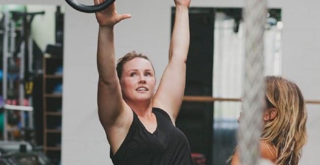 A young woman at the gym with her friend